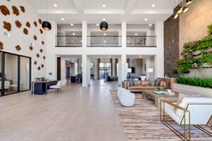 Modern lobby interior with high ceilings, contemporary furniture, and vibrant wall decor.